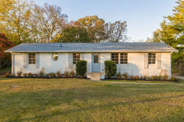 a front view of house with yard and green space