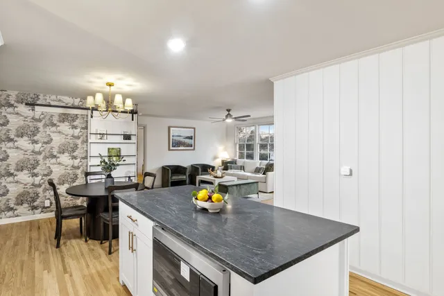 a view of a kitchen with a table and chairs