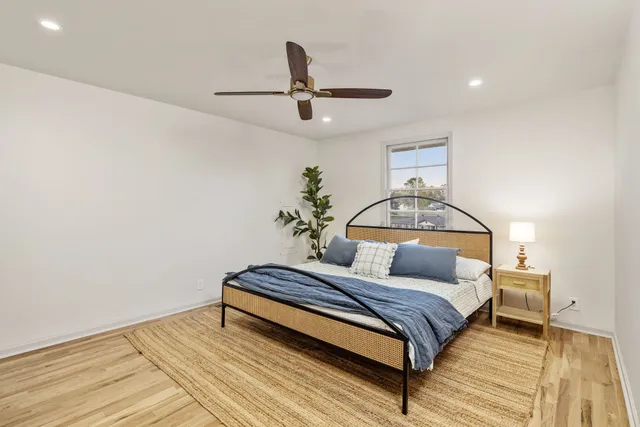 a bedroom with a bed and ceiling fan