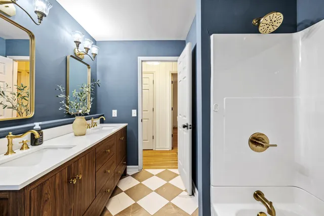 a bathroom with a sink a mirror and a shower