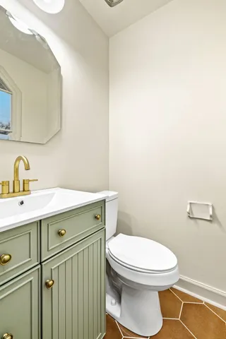 a bathroom with a sink a toilet and mirror