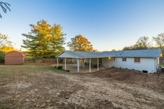 a view of a house with a backyard