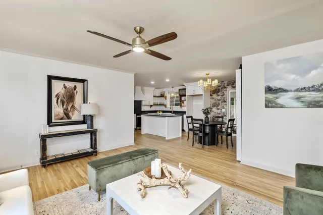 a living room with furniture and kitchen view