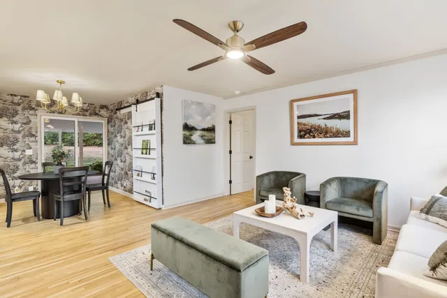 a living room with furniture and wooden floor
