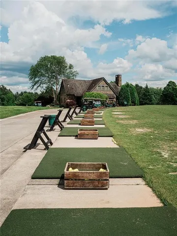 a view of a house with yard and lake view