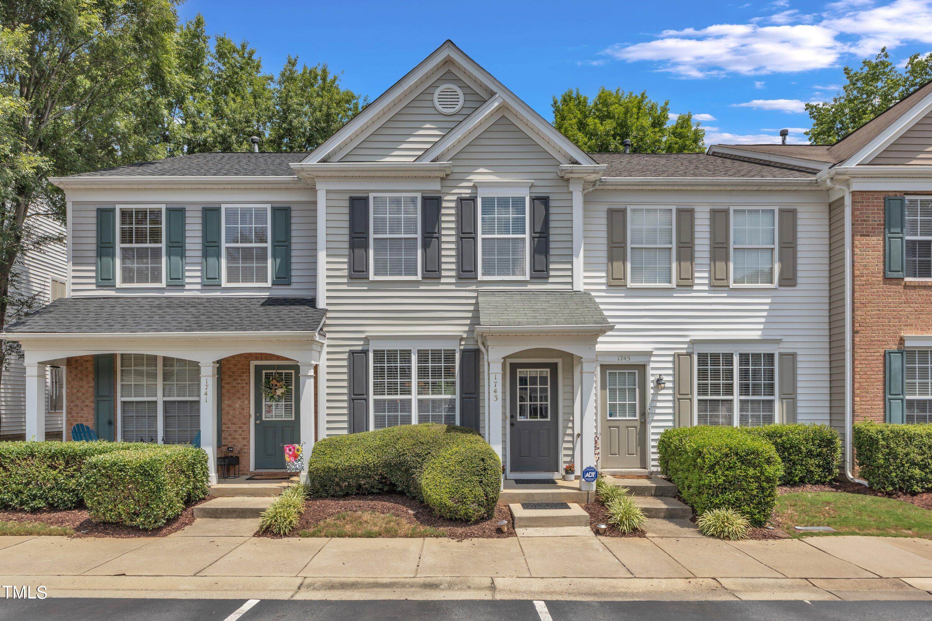 1743 Sorrell Brook Way Raleigh, NC 27609 - Photo 1 of 30 a front view of a house with a yard and potted plants