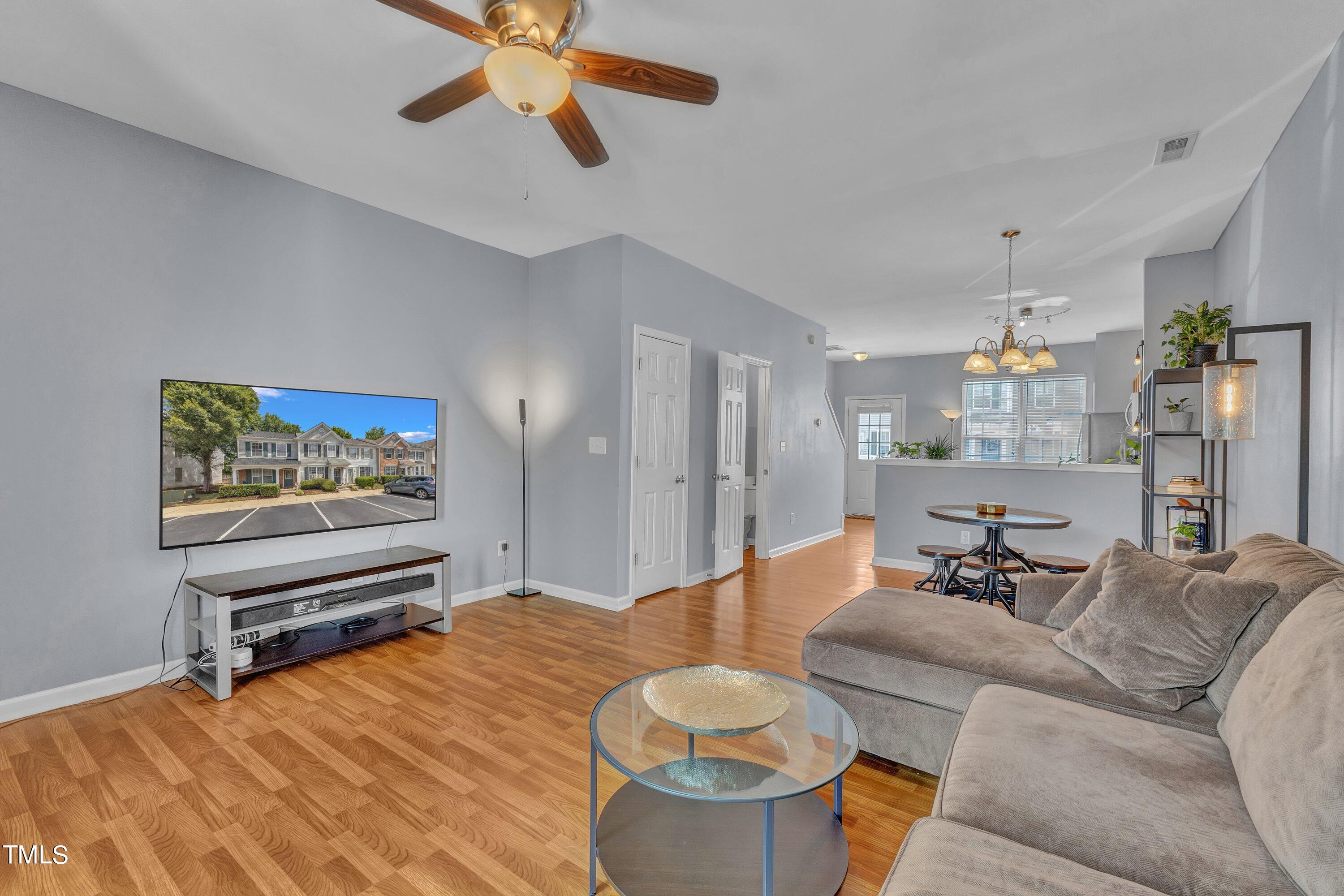 1743 Sorrell Brook Way Raleigh, NC 27609 - Photo 14 of 30 a living room with furniture and a chandelier