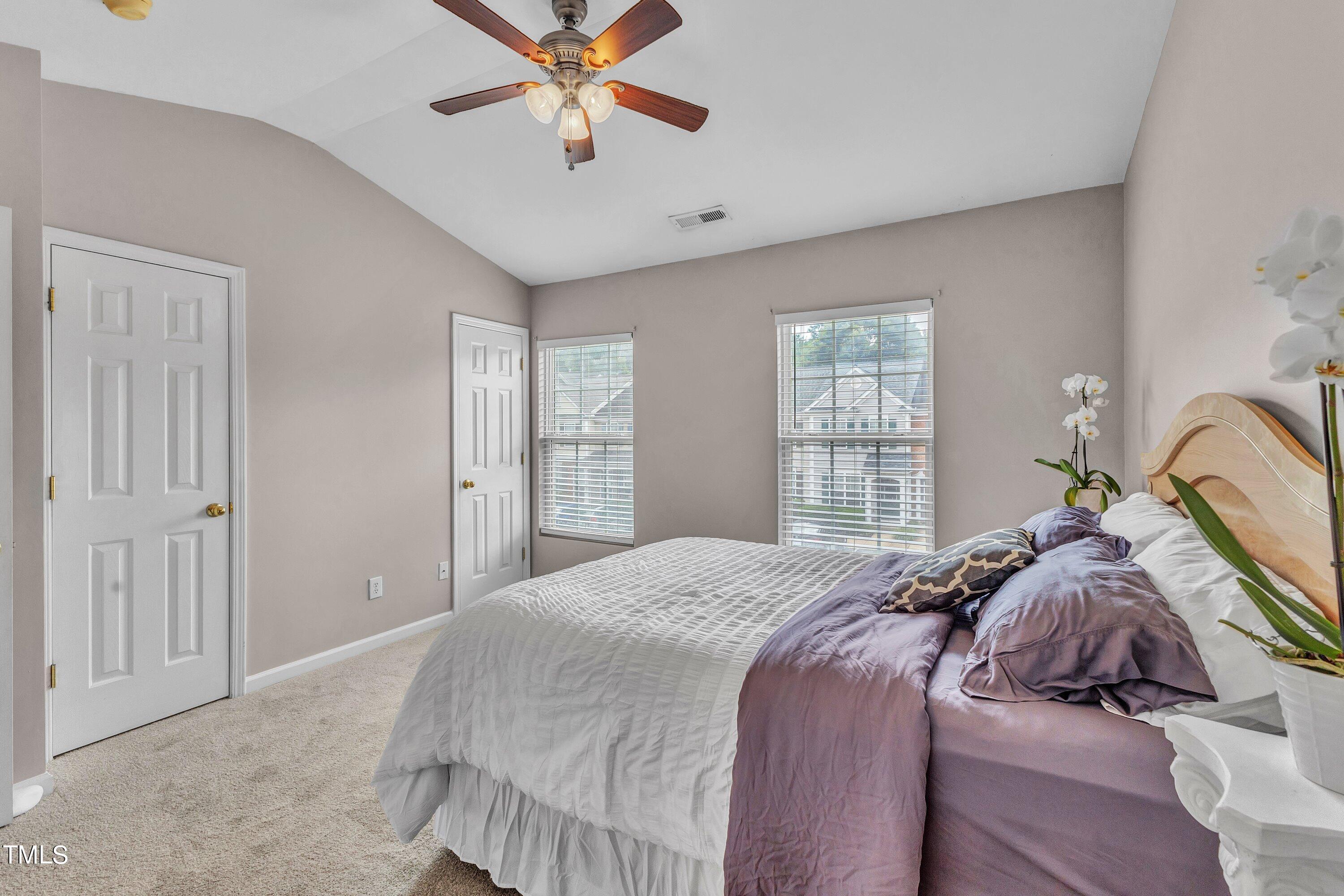 1743 Sorrell Brook Way Raleigh, NC 27609 - Photo 24 of 30 a bedroom with a large bed and a chandelier