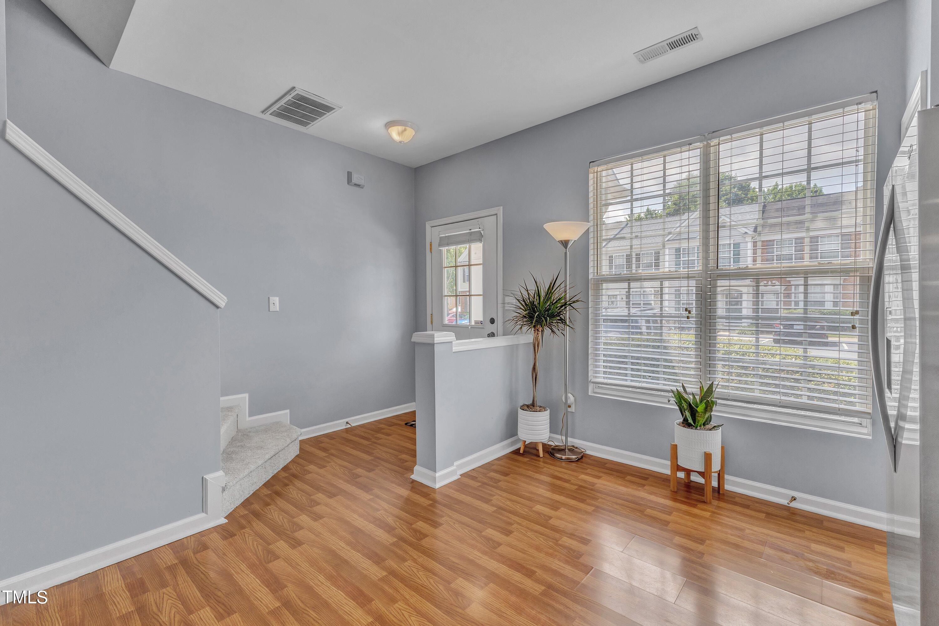 1743 Sorrell Brook Way Raleigh, NC 27609 - Photo 4 of 30 a view of empty room with wooden floor and fan