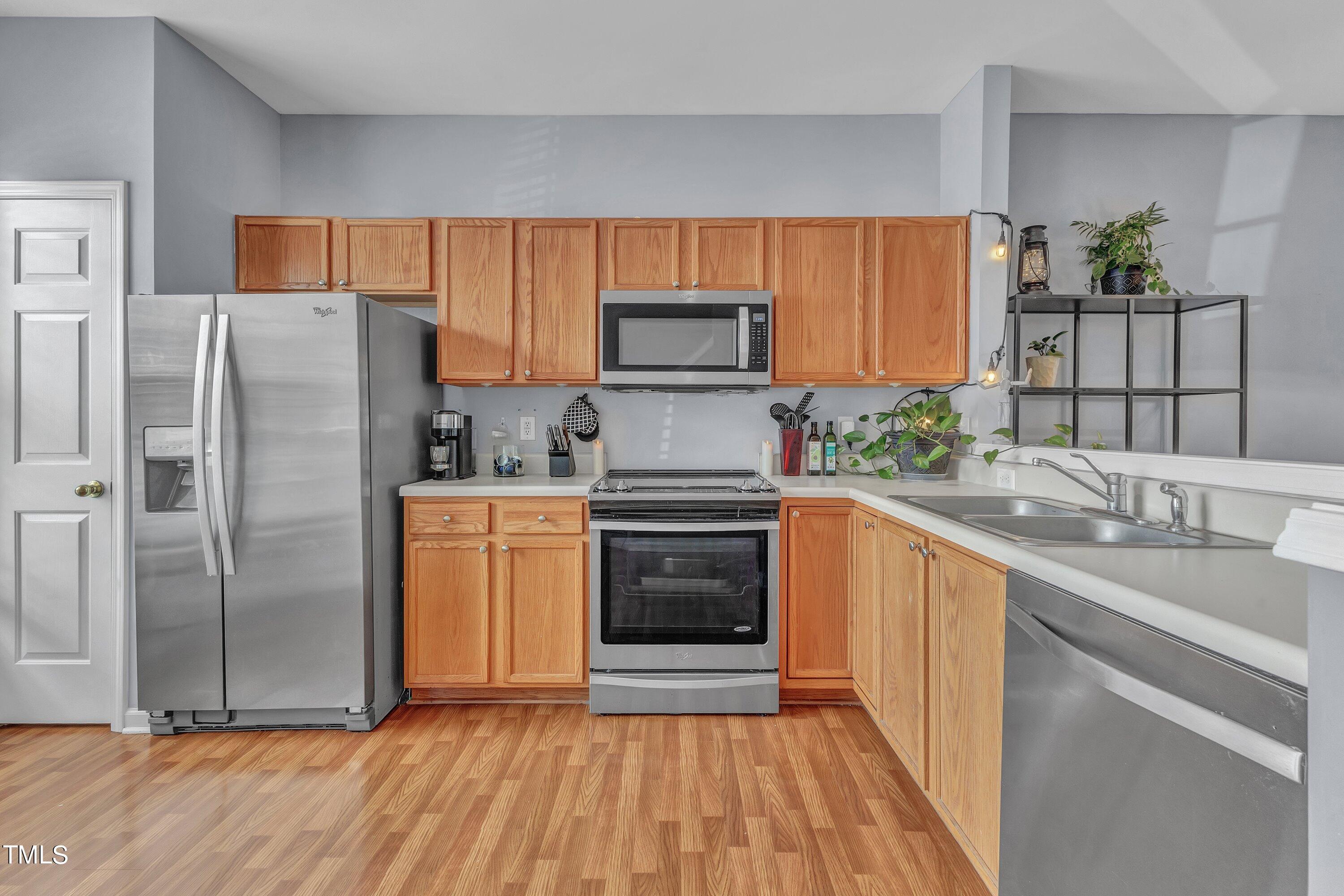 1743 Sorrell Brook Way Raleigh, NC 27609 - Photo 6 of 30 a kitchen with granite countertop a refrigerator and a sink