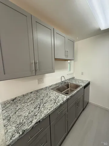 a kitchen with granite countertop cabinets and sink