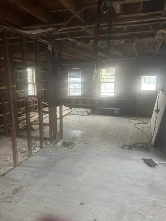 a view of an empty room with a fireplace