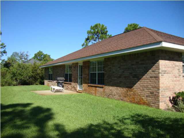 134 East Shipwreck Road Santa Rosa Beach, FL 32459 - Photo 22 of 23 a front view of a house with garden and patio