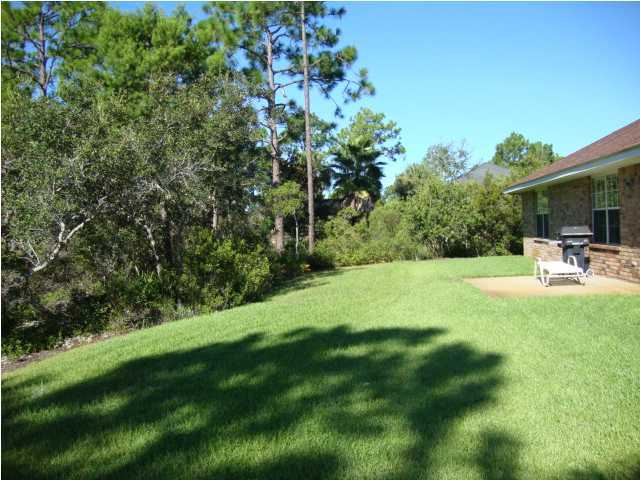 134 East Shipwreck Road Santa Rosa Beach, FL 32459 - Photo 23 of 23 a view of a chair and table in the garden