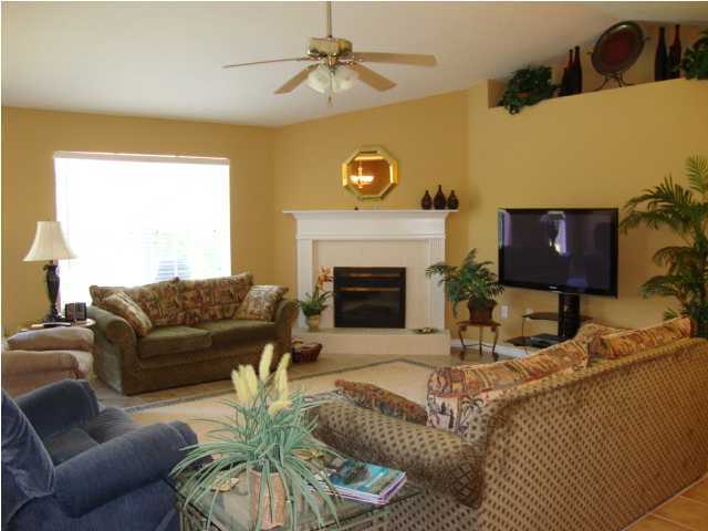 134 East Shipwreck Road Santa Rosa Beach, FL 32459 - Photo 4 of 23 a living room with furniture a fireplace and a flat screen tv