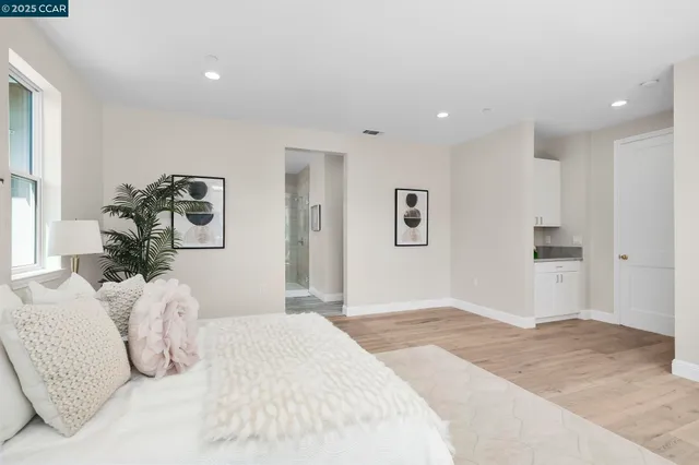 a bedroom with a large bed and a chandelier