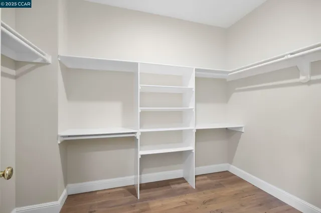 a view of walk in closet with empty racks