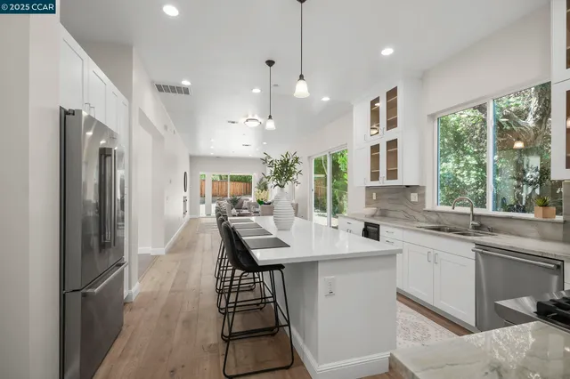 a kitchen with stainless steel appliances a sink stove and refrigerator