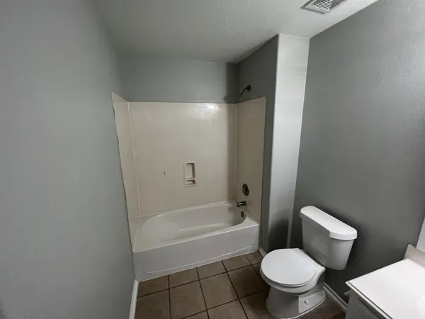 a bathroom with a toilet and a bathtub