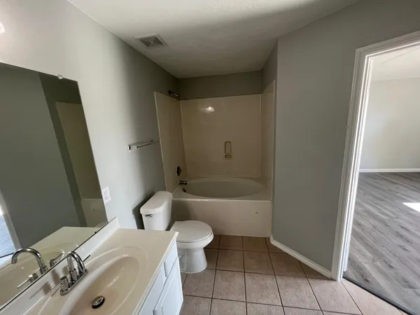 a bathroom with a sink a toilet and tub