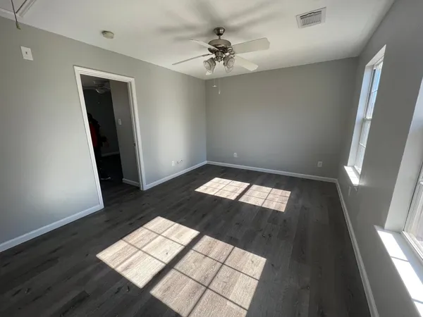 wooden floor in an empty room with a window