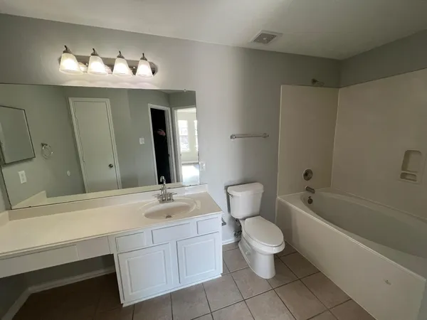 a bathroom with a sink a toilet and a bathtub