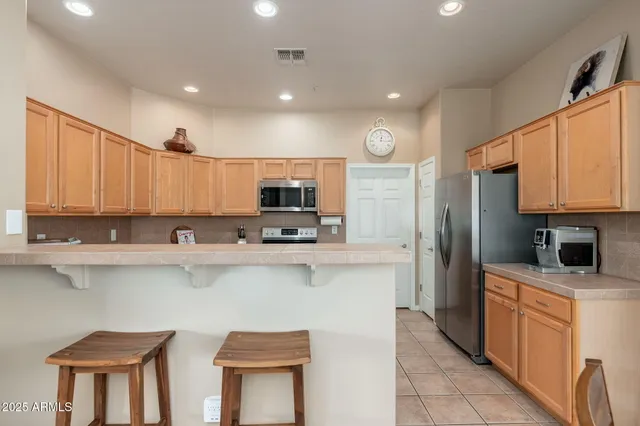 a kitchen with cabinets and a stainless steel appliances