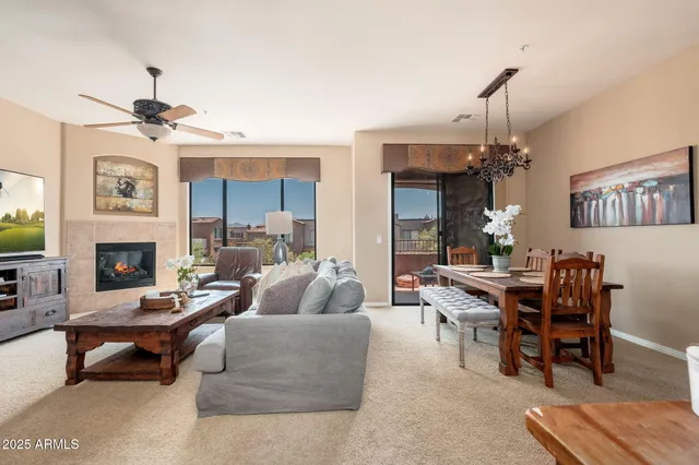 a dining room with furniture a chandelier and a rug