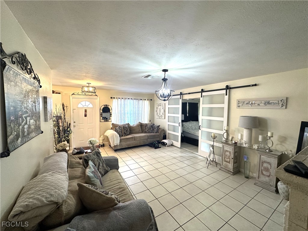 100 Davis Road Lehigh Acres, FL 33936 - Photo 11 of 32 a living room with furniture and a large window