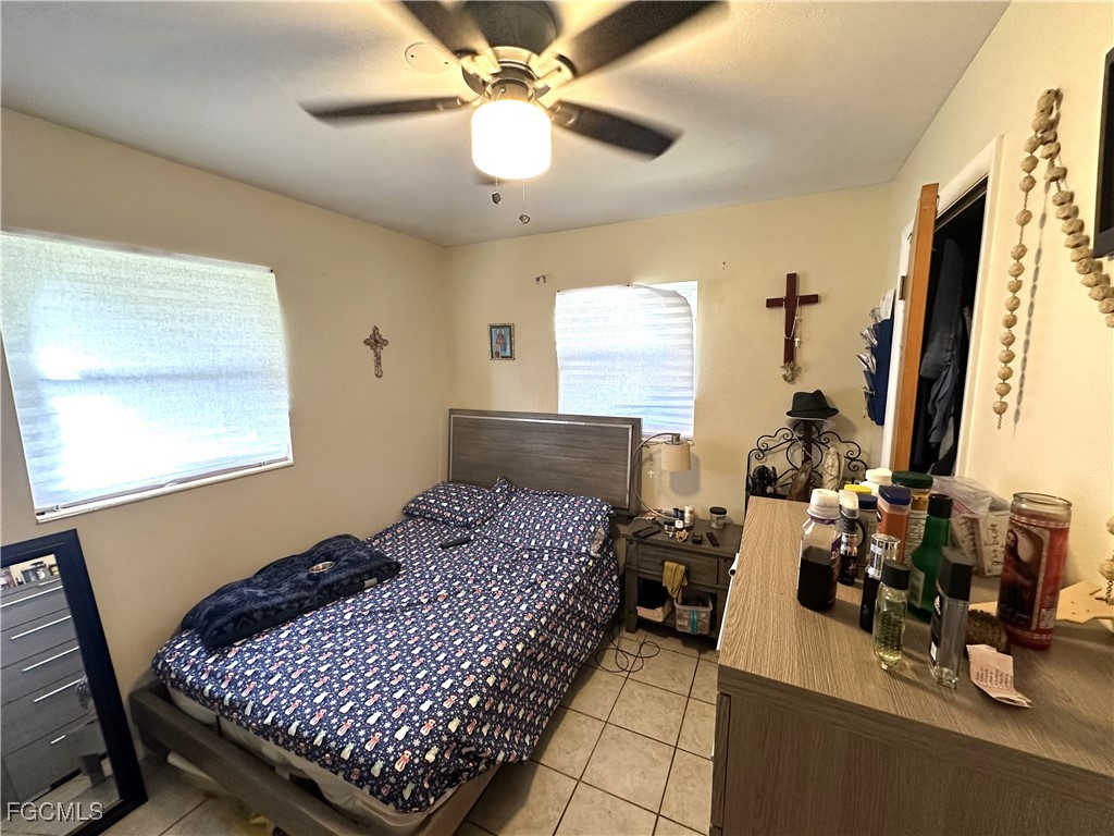 100 Davis Road Lehigh Acres, FL 33936 - Photo 14 of 32 a bedroom with bed and window