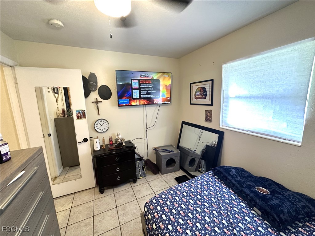 100 Davis Road Lehigh Acres, FL 33936 - Photo 15 of 32 a bedroom with furniture and a window
