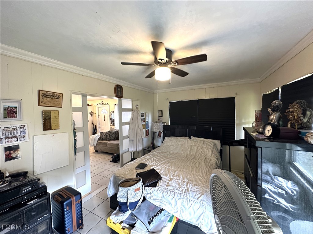 100 Davis Road Lehigh Acres, FL 33936 - Photo 17 of 32 a living room with furniture a flat screen tv and kitchen view