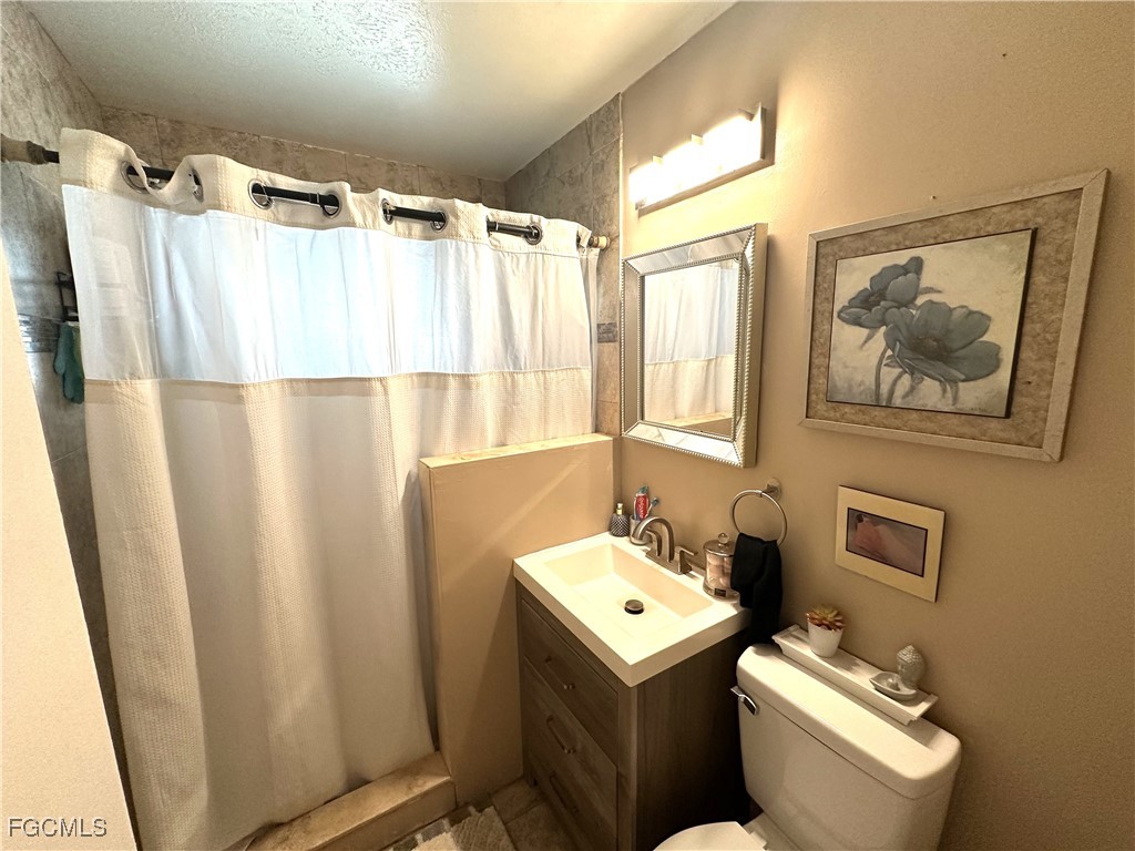 100 Davis Road Lehigh Acres, FL 33936 - Photo 18 of 32 a bathroom with a sink toilet and shower