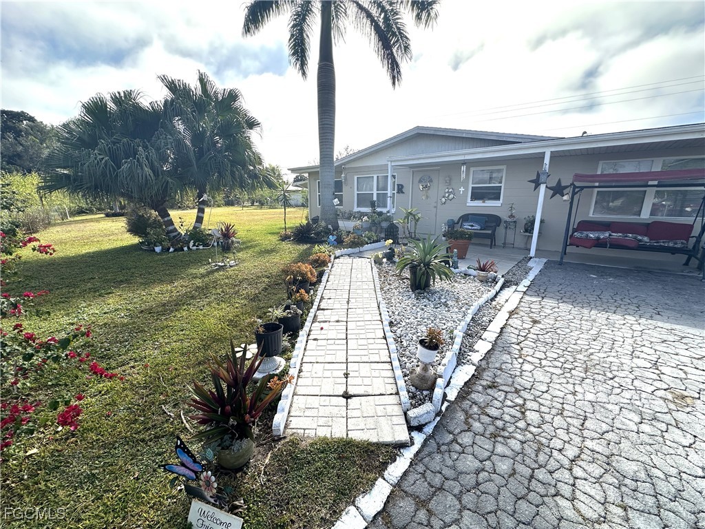 100 Davis Road Lehigh Acres, FL 33936 - Photo 2 of 32 a view of a yard in front of house