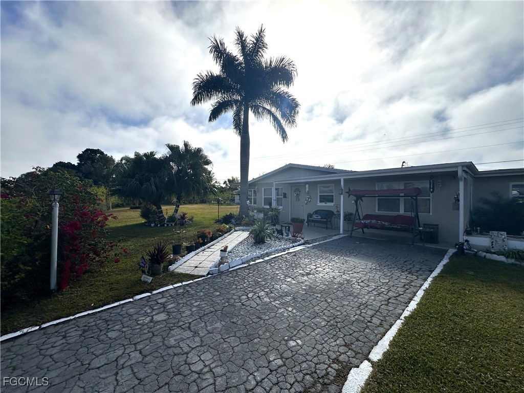 100 Davis Road Lehigh Acres, FL 33936 - Photo 22 of 32 a view of a house with wooden fence