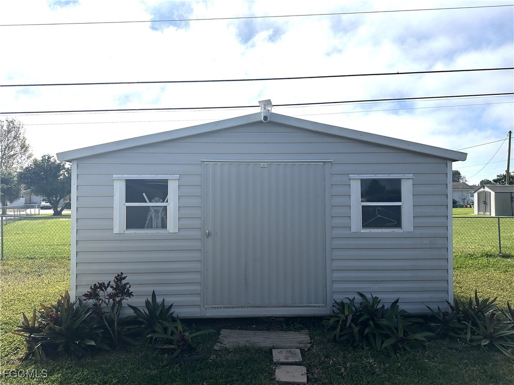 100 Davis Road Lehigh Acres, FL 33936 - Photo 26 of 32 a backyard view with plants and garden