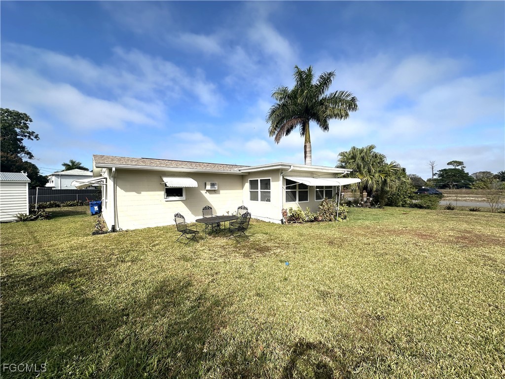 100 Davis Road Lehigh Acres, FL 33936 - Photo 29 of 32 a front view of a house with a yard