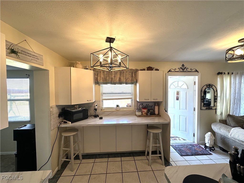100 Davis Road Lehigh Acres, FL 33936 - Photo 6 of 32 a kitchen with a sink appliances and cabinets