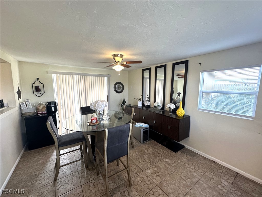 100 Davis Road Lehigh Acres, FL 33936 - Photo 7 of 32 a living room with furniture and a large window