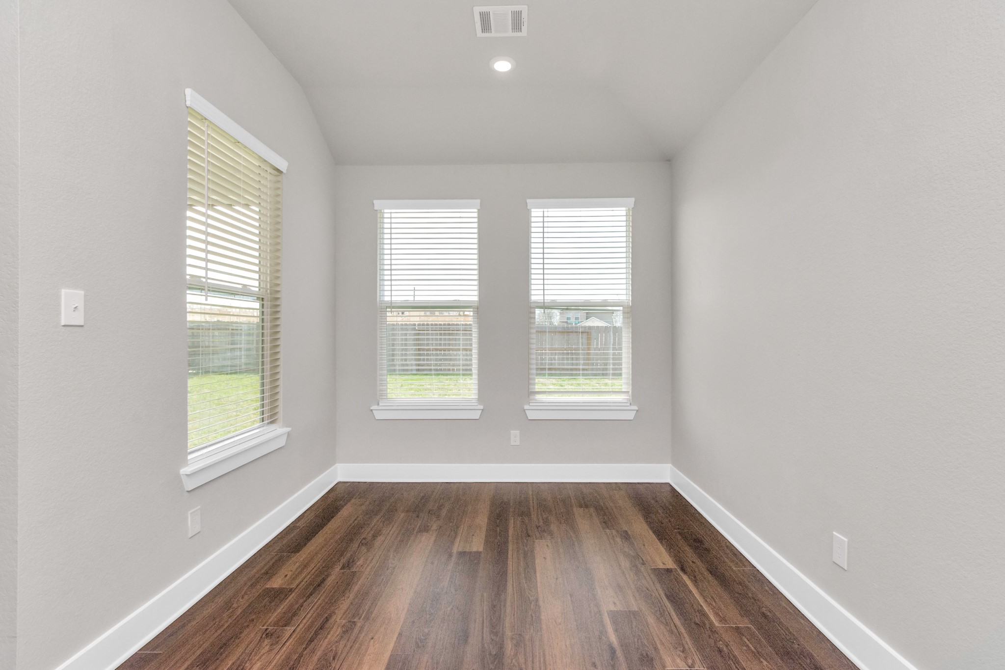 10502 Moon Valley Lane Rosharon, TX 77583 - Photo 5 of 23 an empty room with wooden floor and windows