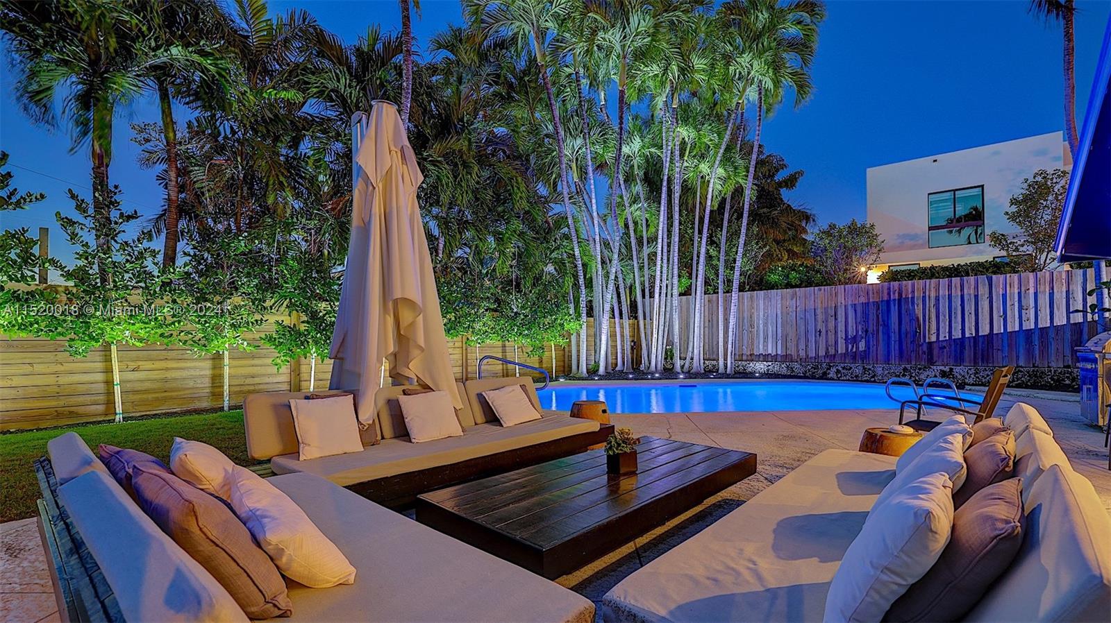 5250 Alton Road Miami Beach, FL 33140 - Photo 1 of 30 a view of a backyard with a patio and outdoor seating