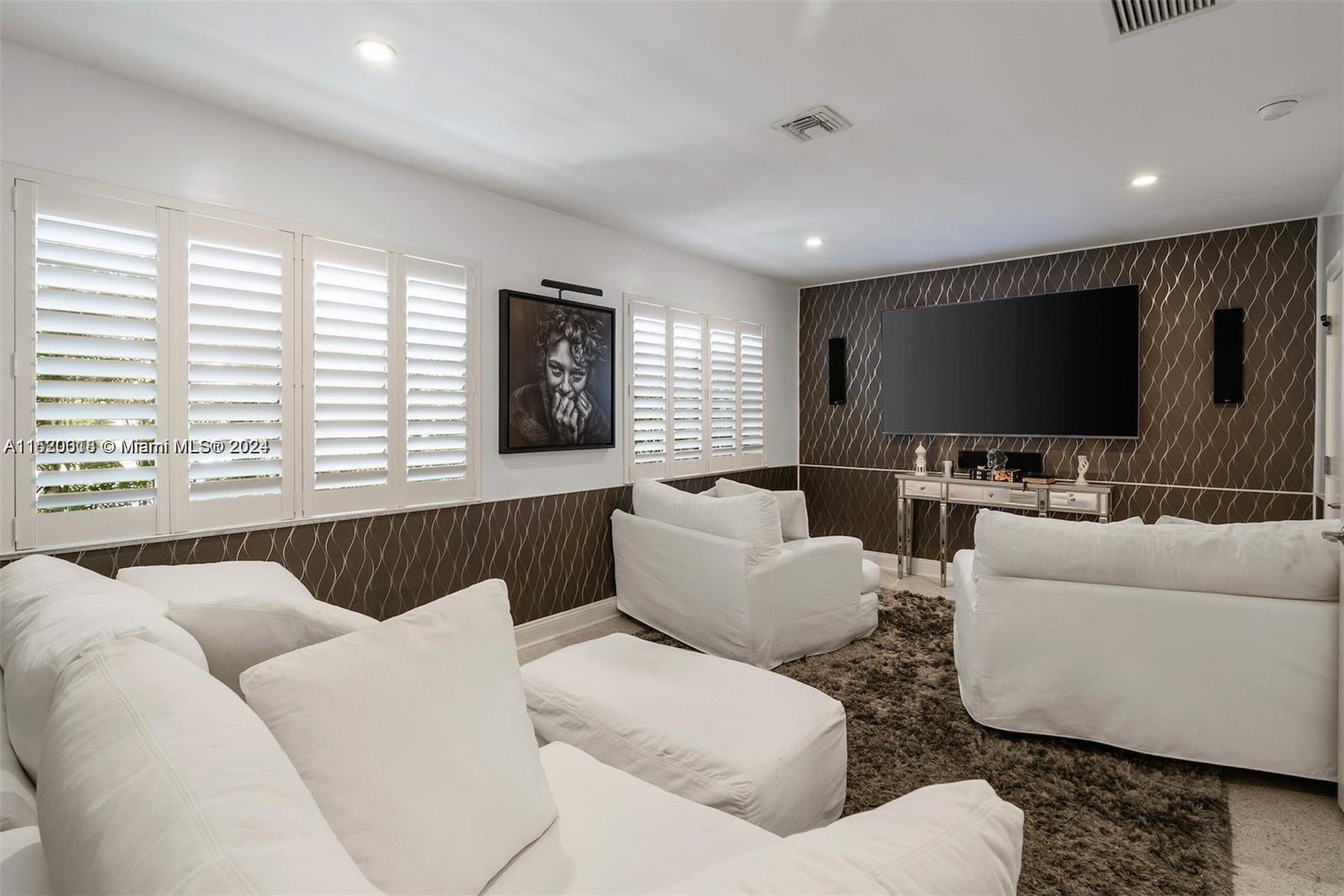 5250 Alton Road Miami Beach, FL 33140 - Photo 13 of 30 a living room with furniture and a flat screen tv