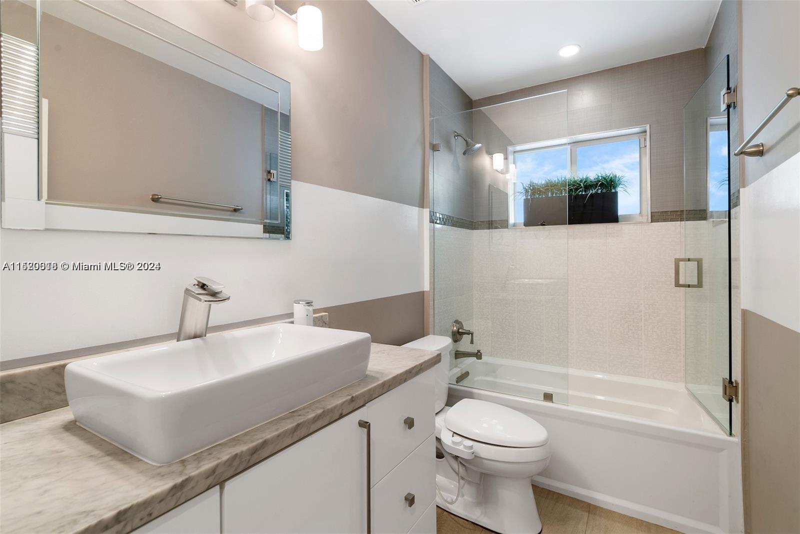 5250 Alton Road Miami Beach, FL 33140 - Photo 15 of 30 a bathroom with a sink a toilet and shower