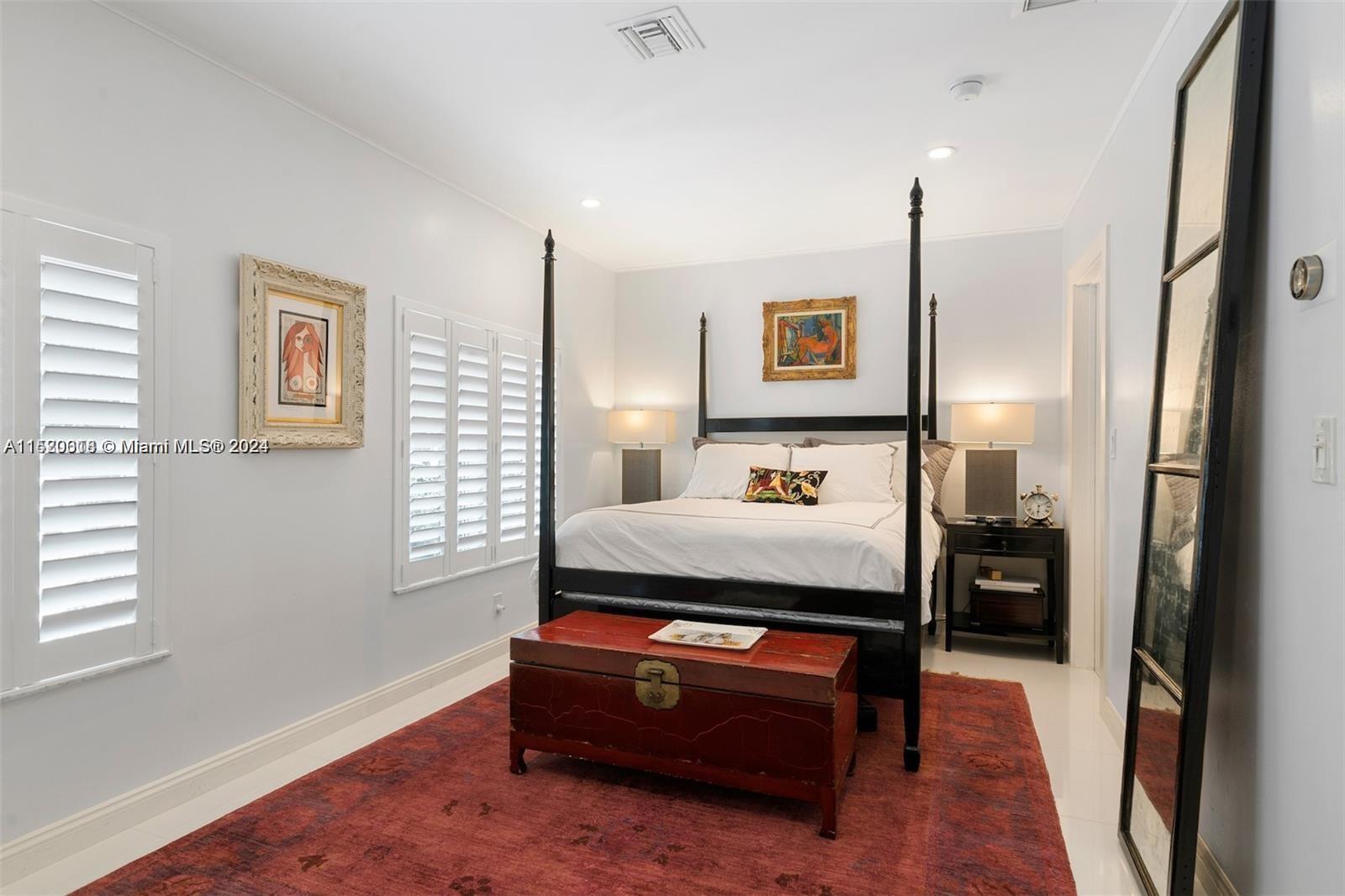5250 Alton Road Miami Beach, FL 33140 - Photo 16 of 30 a bedroom with furniture and a window