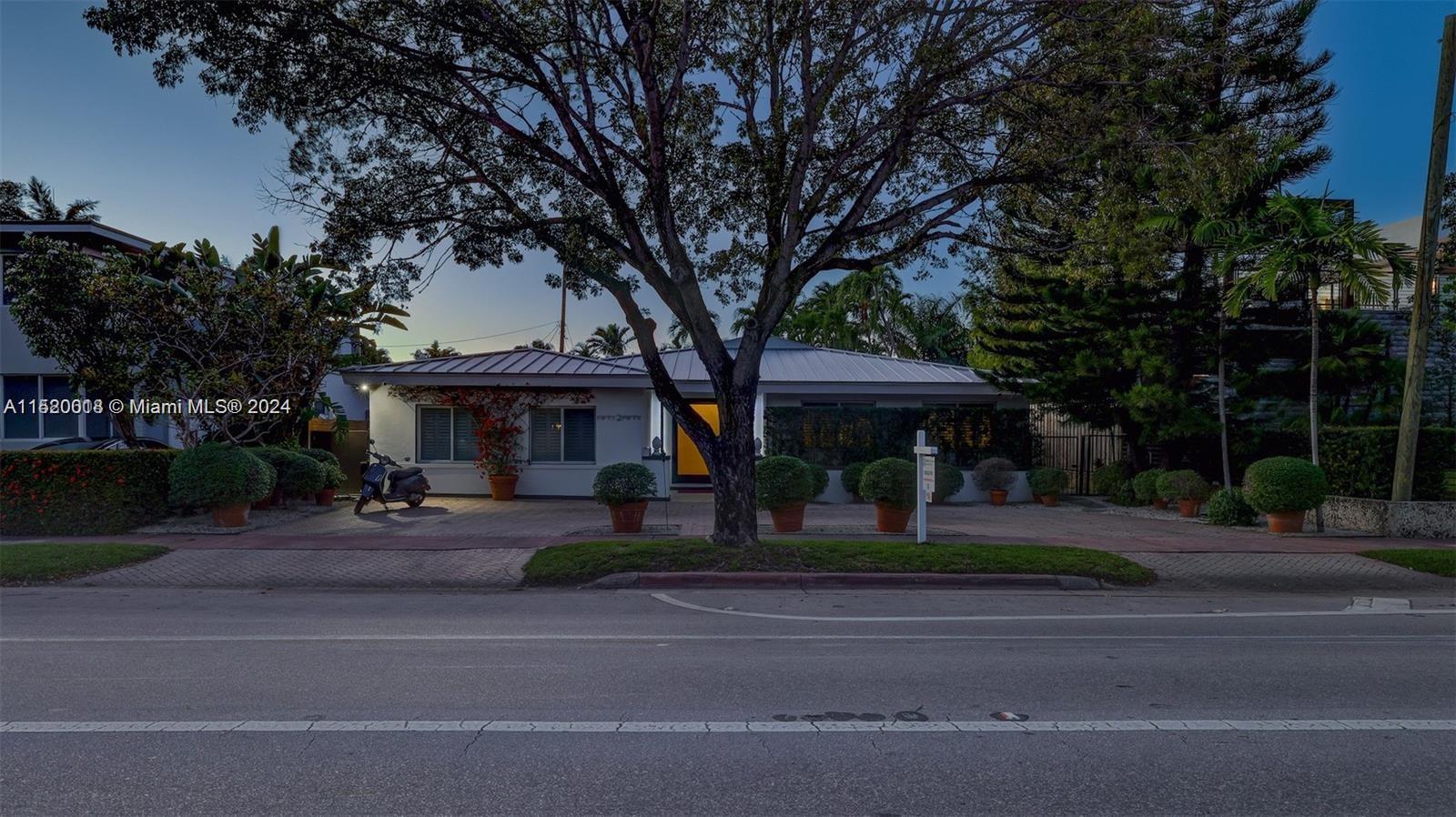 5250 Alton Road Miami Beach, FL 33140 - Photo 26 of 30 a front view of a house with garden