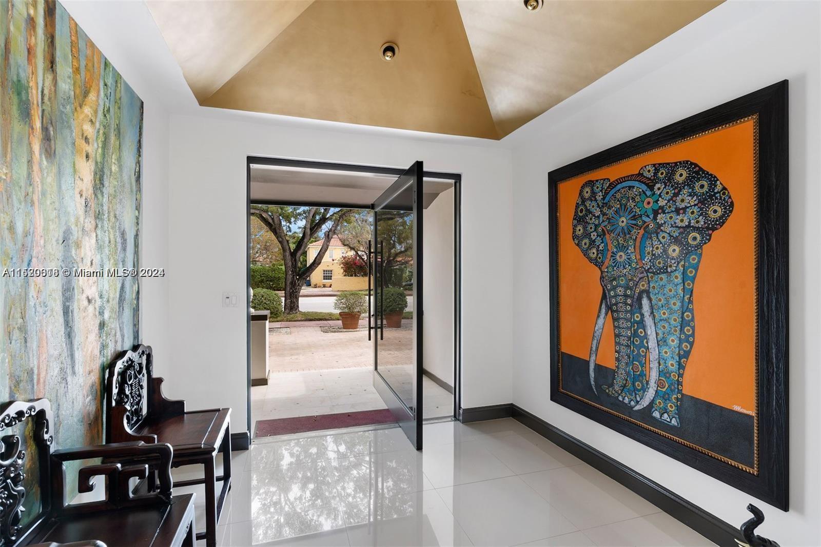 5250 Alton Road Miami Beach, FL 33140 - Photo 3 of 30 a view of a hallway with furniture and front door