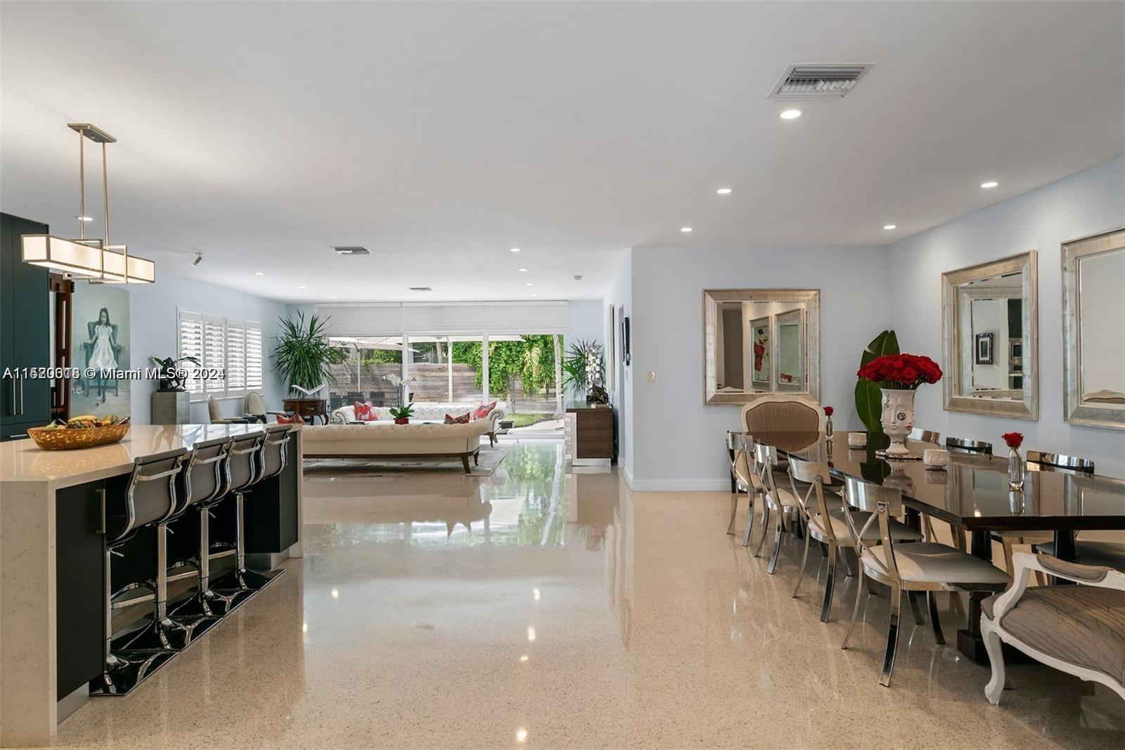 5250 Alton Road Miami Beach, FL 33140 - Photo 4 of 30 a living room with lots of furniture and kitchen view