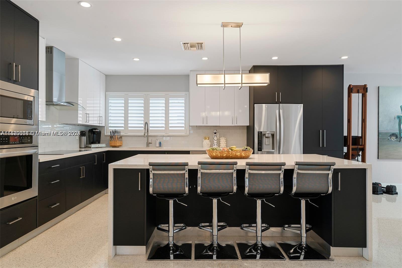5250 Alton Road Miami Beach, FL 33140 - Photo 6 of 30 a kitchen with granite countertop a sink stainless steel appliances and cabinets