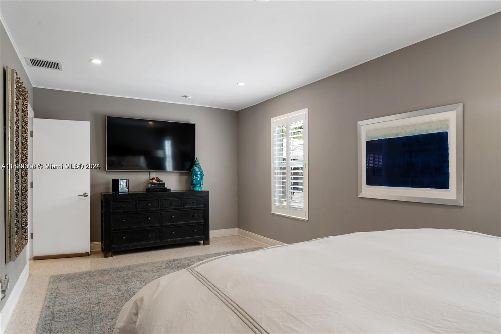 5250 Alton Road Miami Beach, FL 33140 - Photo 9 of 30 a bedroom with a bed and a flat screen tv