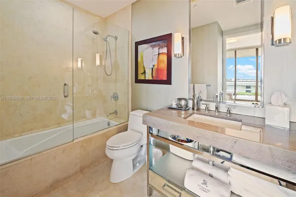 a spacious bathroom with a granite countertop sink mirror toilet and bathtub